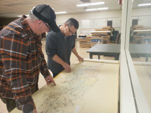 Frank Sindaco, EPCAMR GIS Watershed Outreach Specialist looking over a 1968 Mine Pool Map with the Executive Director, Bobby Hughes. 